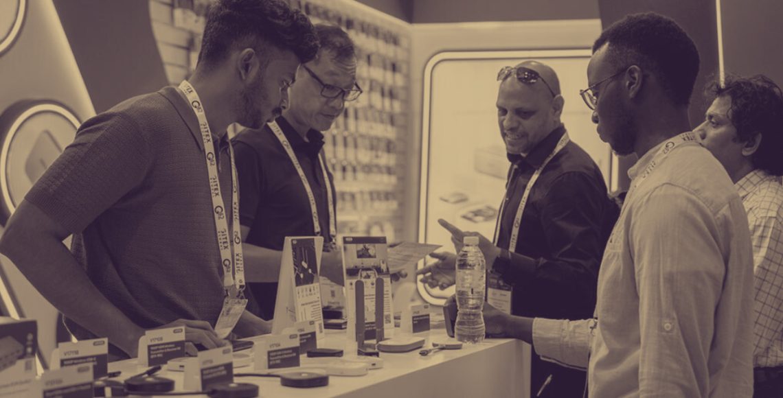 People standing at exhibition stand in Dubai.