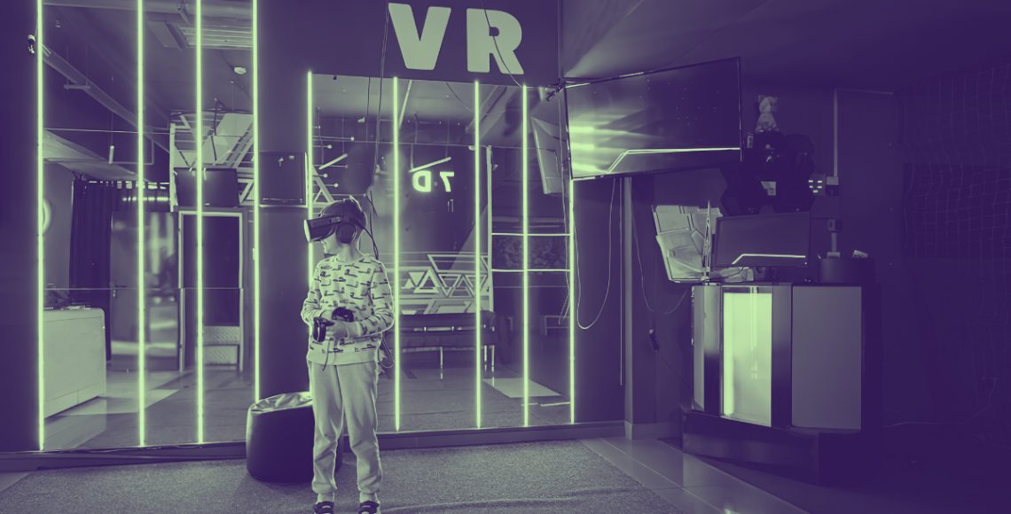 A boy experiencing VR at exhibition booth.